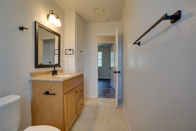 8113 Tumbleweed Trl, White Settlement, TX 76108 - bathroom with toilet, tile patterned flooring, vanity, and baseboards