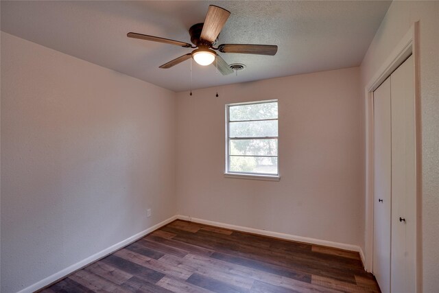8113 Tumbleweed Trl, White Settlement, TX 76108 - unfurnished bedroom with dark wood-style floors, baseboards, a closet, and a ceiling fan