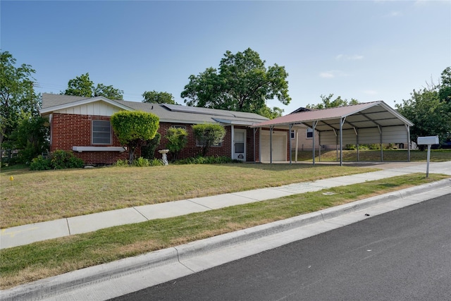 8113 Tumbleweed Trl, White Settlement, TX 76108 - single story home featuring brick siding, roof mounted solar panels, a front yard, and a carport