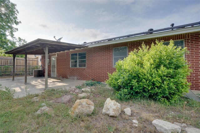 8113 Tumbleweed Trl, White Settlement, TX 76108 - rear view of property featuring fence, a patio area, brick siding, and central AC unit