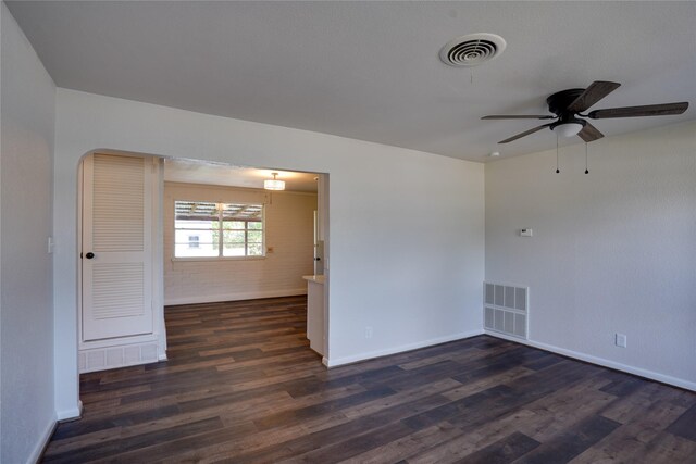 8113 Tumbleweed Trl, White Settlement, TX 76108 - unfurnished room with dark wood-style flooring, a ceiling fan, baseboards, and arched walkways