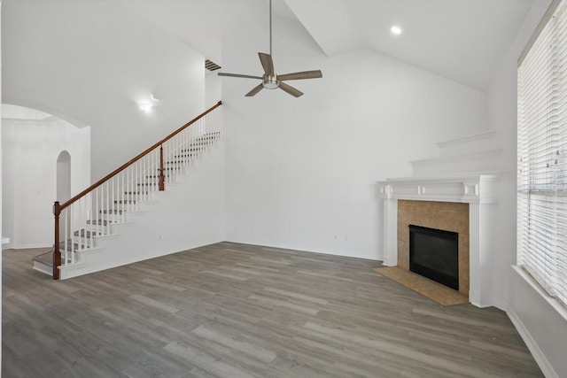 1228 Carriage Creek Dr, Desoto, TX 75115 - unfurnished living room with ceiling fan, stairs, high vaulted ceiling, arched walkways, and a tiled fireplace