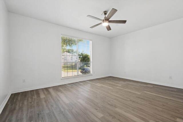 1228 Carriage Creek Dr, Desoto, TX 75115 - spare room featuring wood finished floors, a ceiling fan, and baseboards