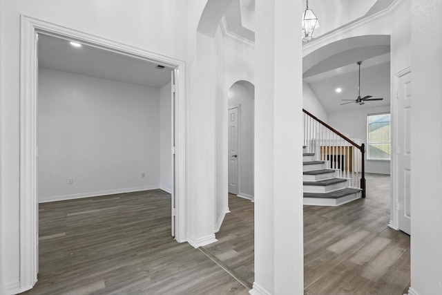 1228 Carriage Creek Dr, Desoto, TX 75115 - foyer entrance featuring arched walkways, ceiling fan, wood finished floors, stairs, and lofted ceiling