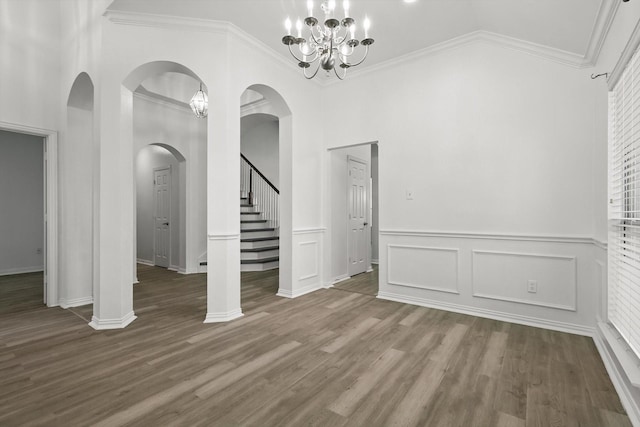 1228 Carriage Creek Dr, Desoto, TX 75115 - unfurnished dining area with arched walkways, wood finished floors, crown molding, high vaulted ceiling, and stairs