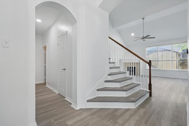 1228 Carriage Creek Dr, Desoto, TX 75115 - staircase featuring arched walkways, wood finished floors, ceiling fan, baseboards, and vaulted ceiling