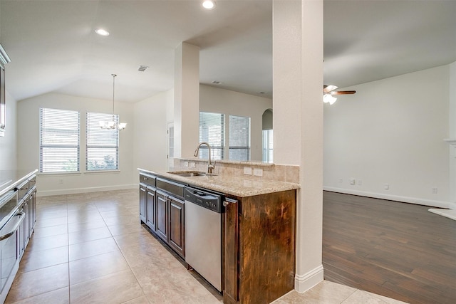 5232 Buffalo Gap Trl, Fort Worth, TX 76126 - kitchen featuring stainless steel dishwasher, a sink, a ceiling fan, arched walkways, and light stone countertops