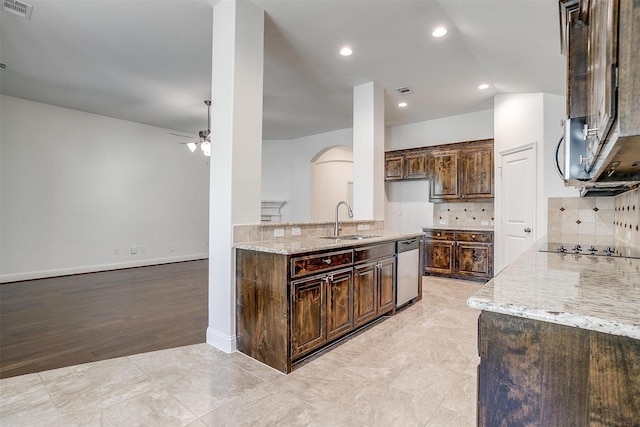 5232 Buffalo Gap Trl, Fort Worth, TX 76126 - kitchen featuring a sink, dishwasher, arched walkways, light stone countertops, and a ceiling fan
