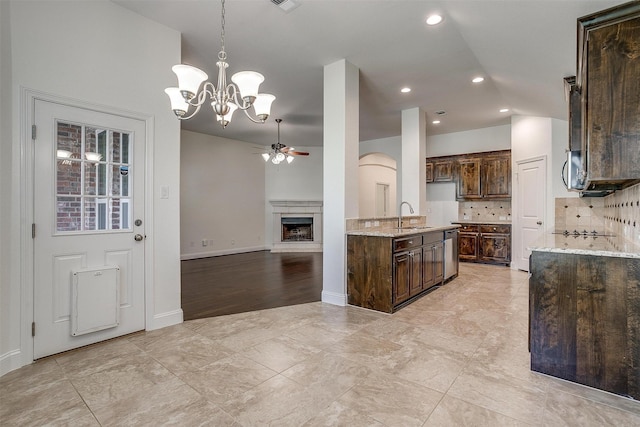 5232 Buffalo Gap Trl, Fort Worth, TX 76126 - kitchen with dishwasher, a sink, a ceiling fan, dark brown cabinets, and a chandelier