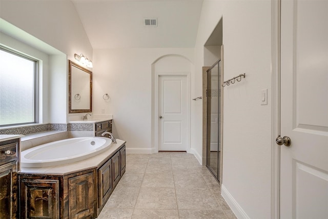 5232 Buffalo Gap Trl, Fort Worth, TX 76126 - bathroom featuring a garden tub, a stall shower, lofted ceiling, vanity, and baseboards