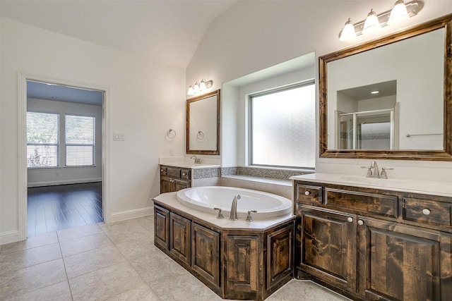 5232 Buffalo Gap Trl, Fort Worth, TX 76126 - bathroom featuring lofted ceiling, healthy amount of natural light, a garden tub, a shower stall, and two vanities