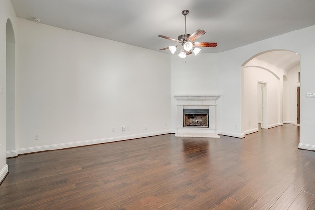 5232 Buffalo Gap Trl, Fort Worth, TX 76126 - unfurnished living room featuring a ceiling fan, wood finished floors, a fireplace with raised hearth, and baseboards