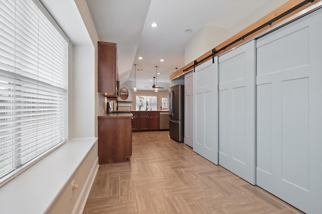 217 Arabian Rd, Waxahachie, TX 75165 - kitchen featuring stainless steel appliances, a barn door, recessed lighting, a peninsula, and a sink