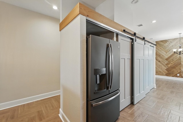 217 Arabian Rd, Waxahachie, TX 75165 - kitchen with stainless steel refrigerator with ice dispenser, baseboards, a barn door, wood walls, and recessed lighting