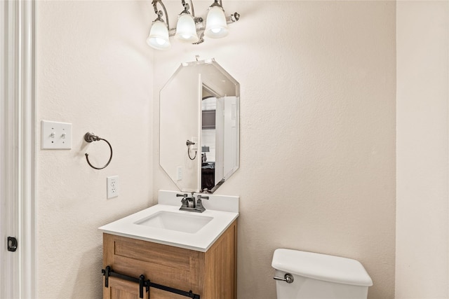 2001 Longfellow Ln, Flower Mound, TX 75028 - half bath with toilet, vanity, and a chandelier