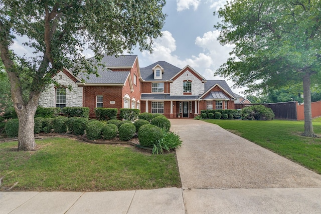 2001 Longfellow Ln, Flower Mound, TX 75028 - view of front facade featuring concrete driveway, brick siding, a front lawn, and stone siding