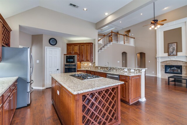2001 Longfellow Ln, Flower Mound, TX 75028 - kitchen with appliances with stainless steel finishes, a peninsula, ceiling fan, a sink, and a kitchen island