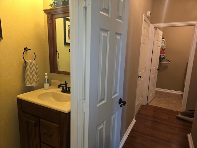 4820 Rum St, Fort Worth, TX 76244 - bathroom with vanity, wood finished floors, and baseboards