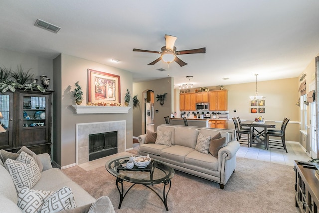 4820 Rum St, Fort Worth, TX 76244 - living room featuring a ceiling fan, a fireplace, light tile patterned floors, light carpet, and baseboards