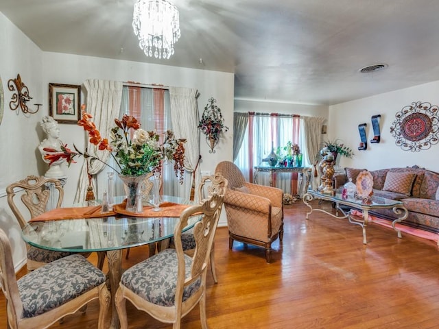 6802 Seco Blvd, Dallas, TX 75217 - dining room with wood finished floors and a chandelier