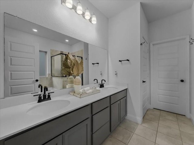 3605 Keechi Creek Dr, Celina, TX 75078 - bathroom featuring a shower, tile patterned flooring, double vanity, and recessed lighting