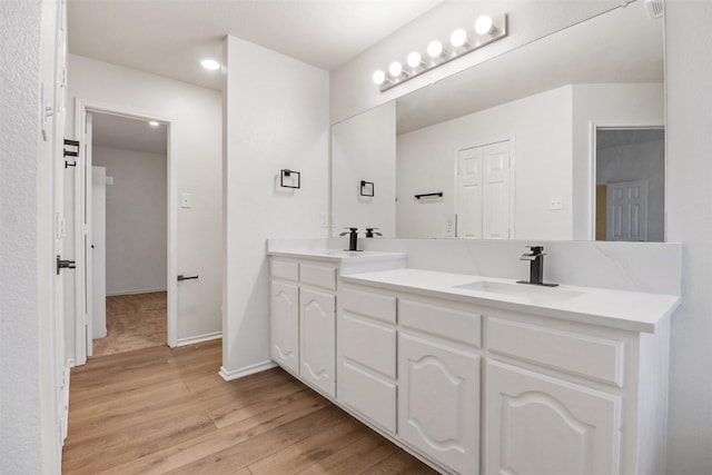9103 Aristocrat Ln, Frisco, TX 75033 - full bath with wood finished floors, double vanity, recessed lighting, and baseboards