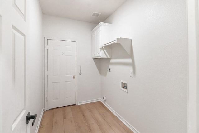 9103 Aristocrat Ln, Frisco, TX 75033 - laundry area featuring hookup for an electric dryer, light wood-type flooring, cabinet space, washer hookup, and baseboards