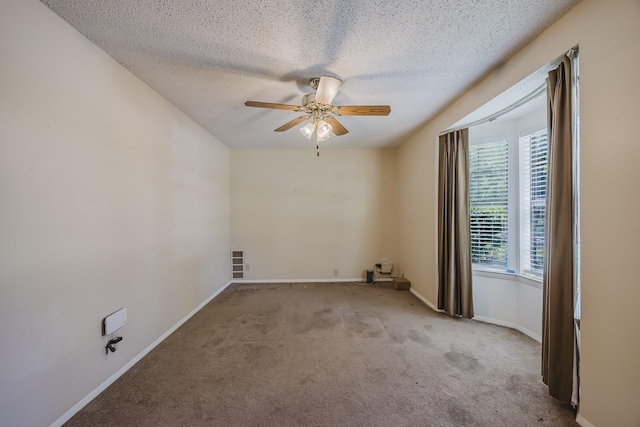 2011 Woodlawn St, Gainesville, TX 76240 - carpeted empty room with ceiling fan, a textured ceiling, and baseboards