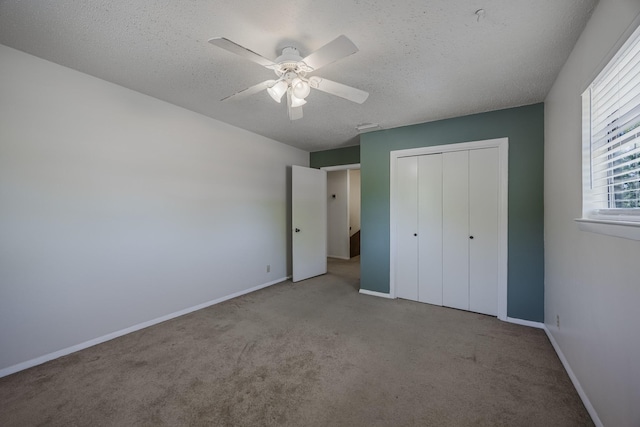 2011 Woodlawn St, Gainesville, TX 76240 - unfurnished bedroom with carpet floors, a closet, a textured ceiling, baseboards, and ceiling fan