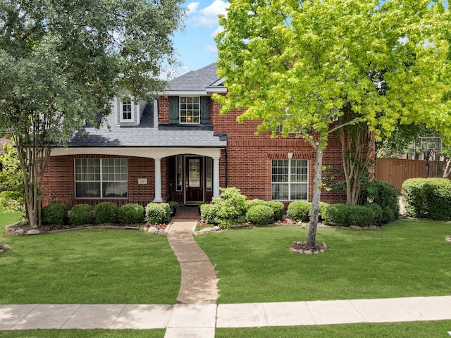 1217 Mandeville Dr, Murphy, TX 75094 - traditional-style home with brick siding, a shingled roof, and covered porch