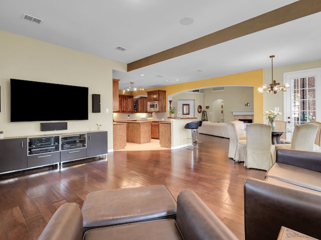 1217 Mandeville Dr, Murphy, TX 75094 - living room with arched walkways, a chandelier, and hardwood / wood-style flooring