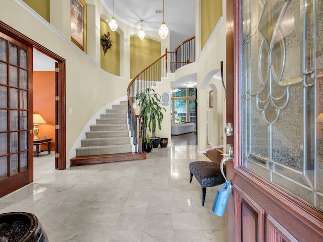 1217 Mandeville Dr, Murphy, TX 75094 - foyer entrance with stairs, a towering ceiling, and arched walkways
