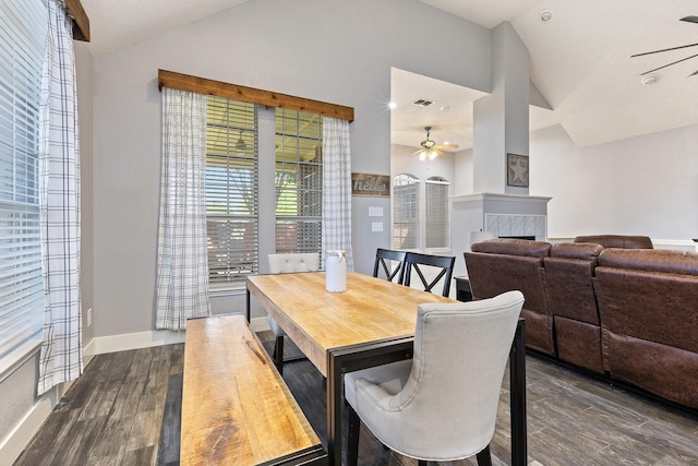 7601 Silverthorn, Rowlett, TX 75089 - dining room featuring ceiling fan, lofted ceiling, a tile fireplace, dark wood finished floors, and baseboards