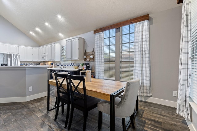 7601 Silverthorn, Rowlett, TX 75089 - dining room with dark wood-style flooring, baseboards, recessed lighting, a textured ceiling, and lofted ceiling
