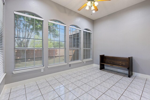 7601 Silverthorn, Rowlett, TX 75089 - unfurnished dining area with ceiling fan and light tile patterned floors