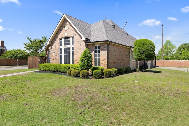 7601 Silverthorn, Rowlett, TX 75089 - view of home's exterior featuring brick siding, a shingled roof, and central AC unit