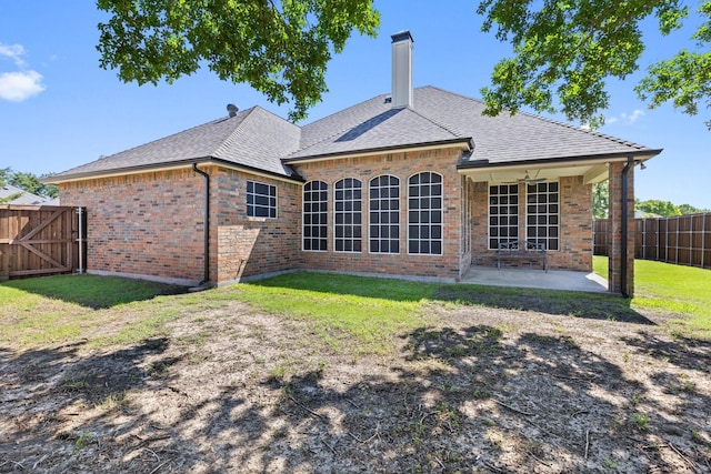 7601 Silverthorn, Rowlett, TX 75089 - back of property with a patio area, brick siding, roof with shingles, and a chimney