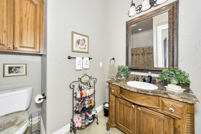 2401 Portwood Way, Fort Worth, TX 76179 - bathroom with baseboards, toilet, and vanity