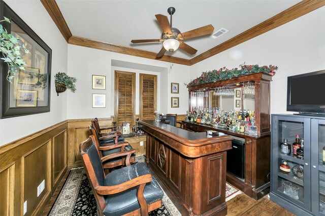 2401 Portwood Way, Fort Worth, TX 76179 - indoor dry bar featuring a wainscoted wall, crown molding, ceiling fan, and dark wood-style floors