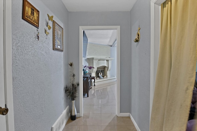 400 E Williamsburg Mnr, Arlington, TX 76014 - corridor featuring a textured wall, baseboards, and light marble finish floors