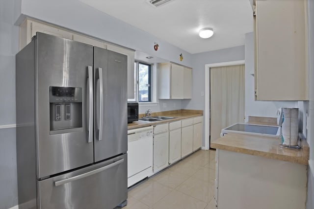 400 E Williamsburg Mnr, Arlington, TX 76014 - kitchen with white appliances, a sink, light countertops, light tile patterned floors, and white cabinetry