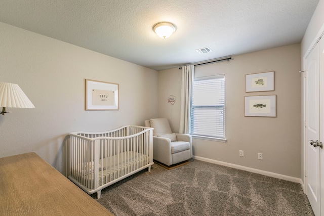 3101 Gilchrist Dr, Waco, TX 76655 - bedroom featuring carpet flooring, baseboards, a nursery area, and a textured ceiling