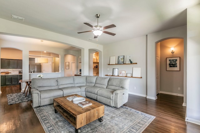 3101 Gilchrist Dr, Waco, TX 76655 - living area featuring arched walkways, a ceiling fan, dark wood-style floors, and baseboards