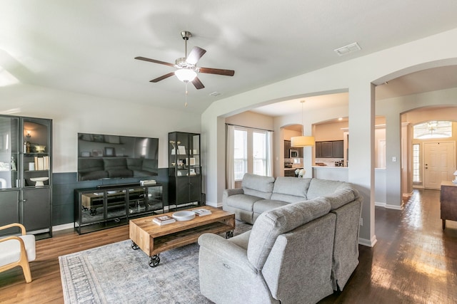 3101 Gilchrist Dr, Waco, TX 76655 - living room featuring arched walkways, wood finished floors, a ceiling fan, and baseboards