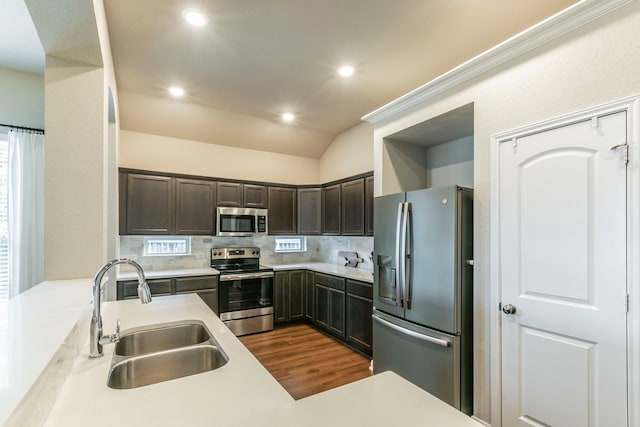 3101 Gilchrist Dr, Waco, TX 76655 - kitchen featuring stainless steel appliances, a sink, dark wood-type flooring, decorative backsplash, and dark brown cabinetry