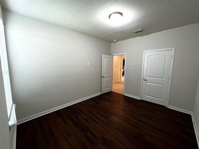 9105 Edenberry Ln, Fort Worth, TX 76179 - unfurnished bedroom featuring dark wood-style flooring and baseboards