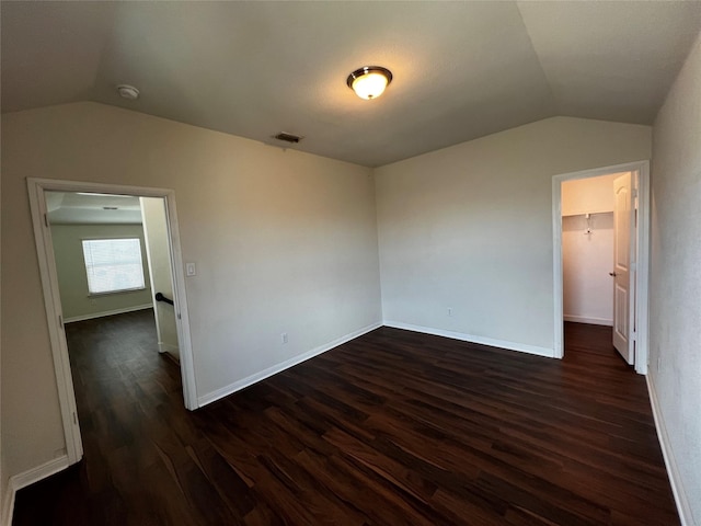 9105 Edenberry Ln, Fort Worth, TX 76179 - unfurnished bedroom with lofted ceiling, dark wood-style floors, a spacious closet, baseboards, and a closet