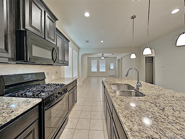 9105 Edenberry Ln, Fort Worth, TX 76179 - kitchen featuring black appliances, a sink, arched walkways, backsplash, and a ceiling fan