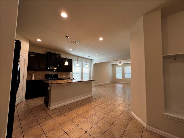 9105 Edenberry Ln, Fort Worth, TX 76179 - kitchen with light tile patterned floors, decorative backsplash, black appliances, open floor plan, and recessed lighting