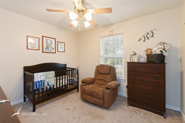 390 Sugarberry Ave, Abilene, TX 79602 - carpeted bedroom featuring a nursery area, baseboards, and ceiling fan